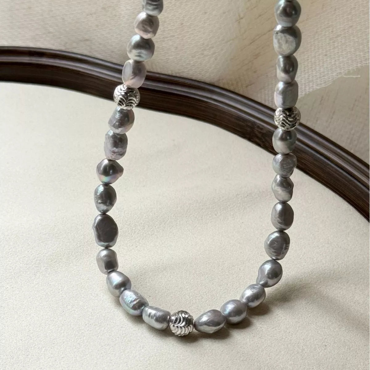 Elegant pearl choker necklace by Plush Fashion Hub featuring a string of lustrous white pearls on a delicate black cord.