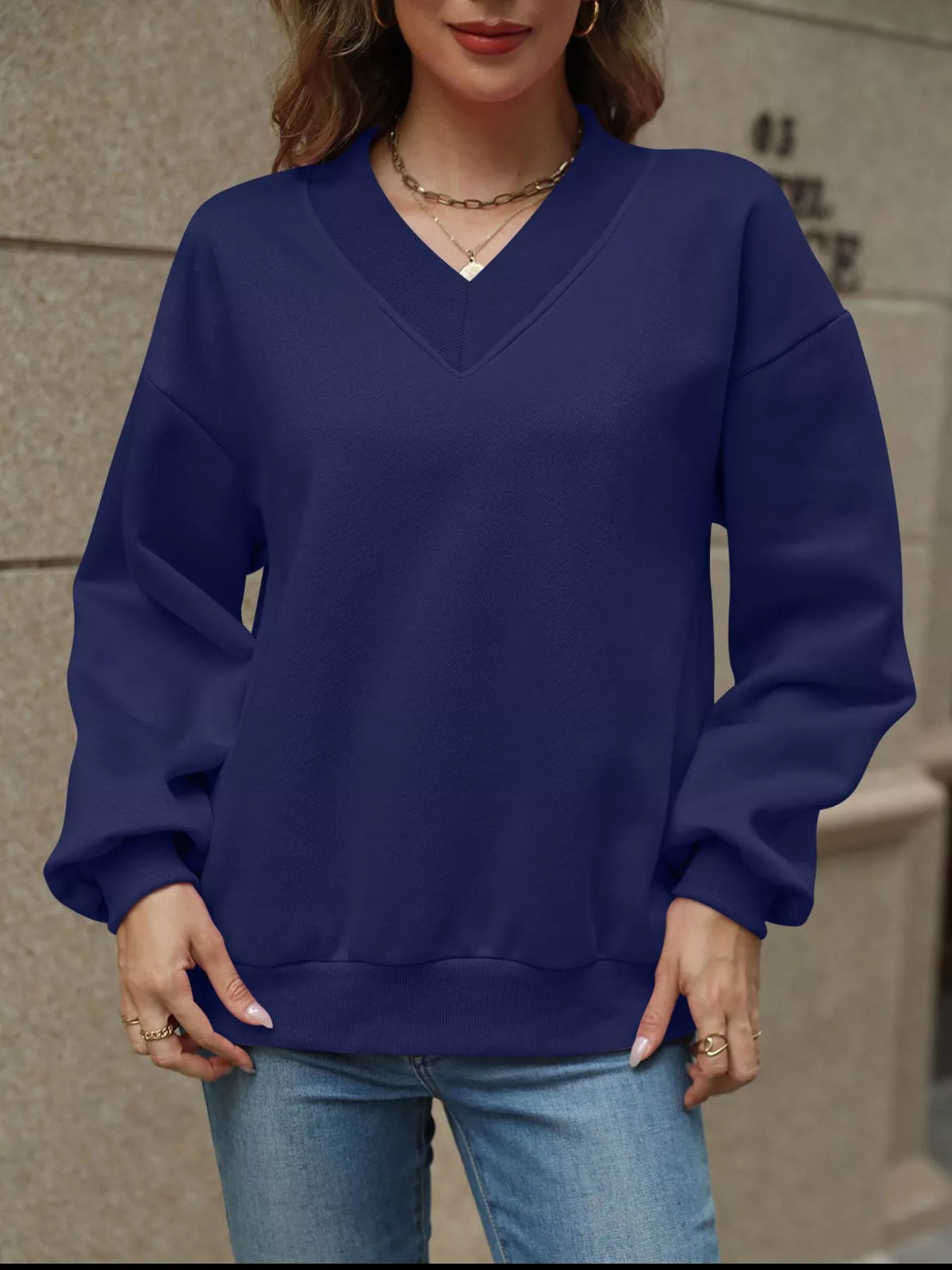 V-neck solid color casual sweatshirt by Trendsi, featuring a relaxed fit and soft fabric, shown in a natural beige shade.