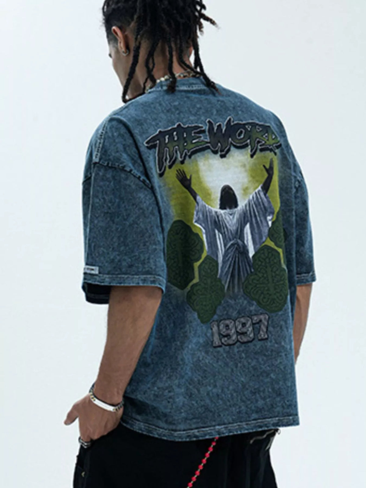 Men's graphic round neck short sleeve T-shirt by Trendsi, featuring a bold design on soft cotton fabric.