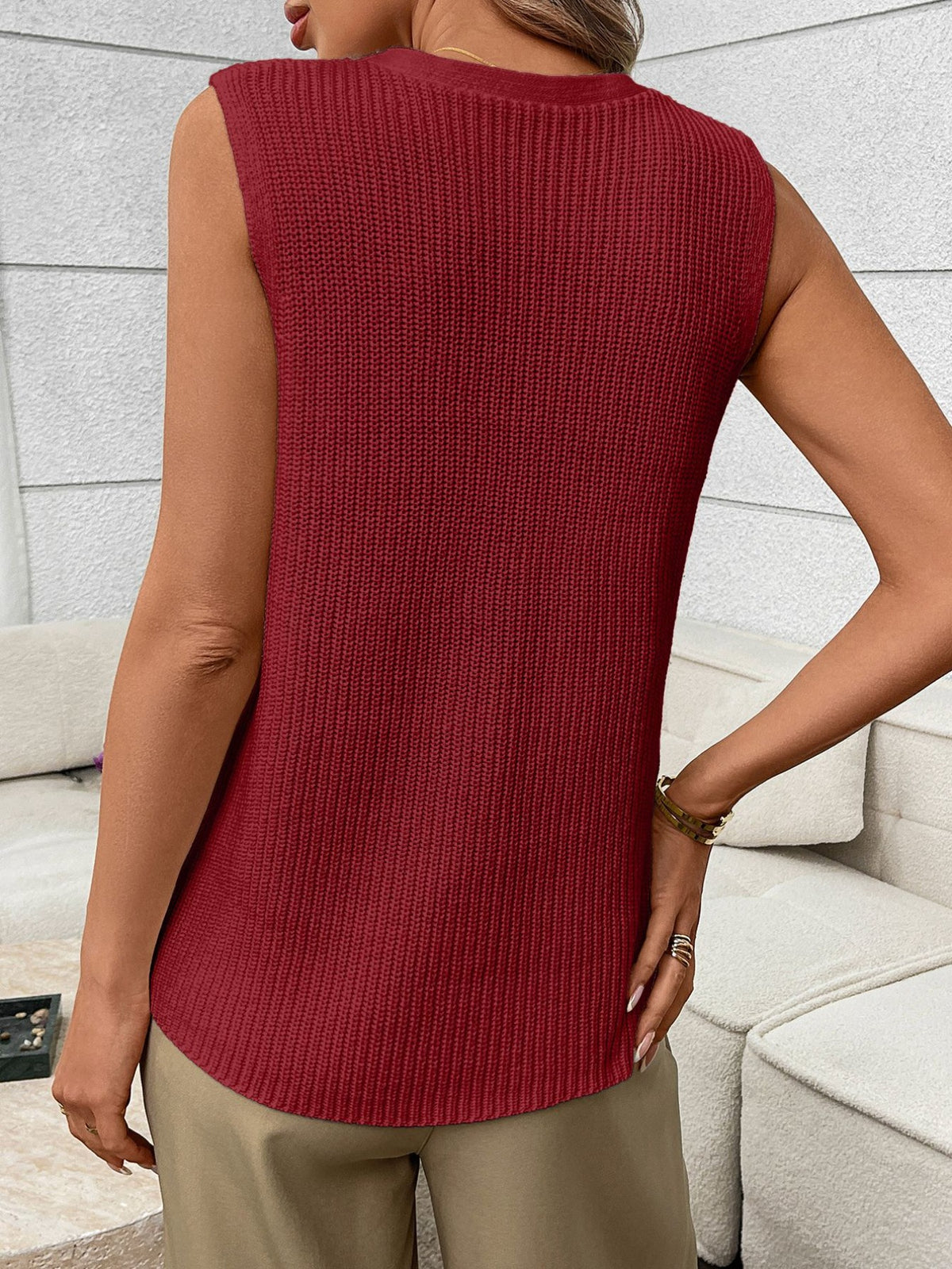 Women's sleeveless knit sweater vest with buttons and side pockets from Plush Fashion Hub, displayed on a neutral background.