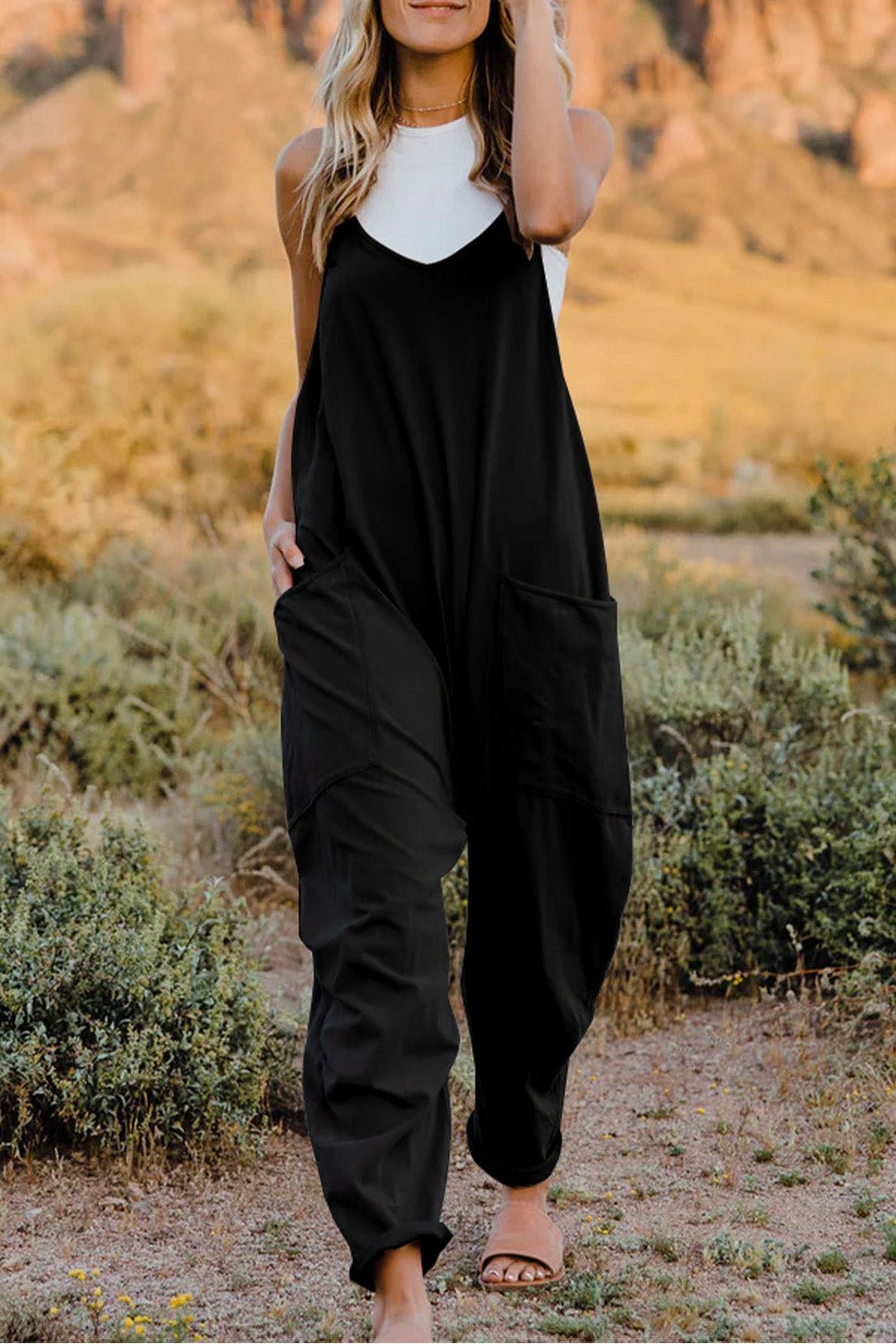 Women’s sleeveless V-neck jumpsuit with pockets, lightweight casual romper from Plush Fashion Hub, full-length, stylish and comfortable.
