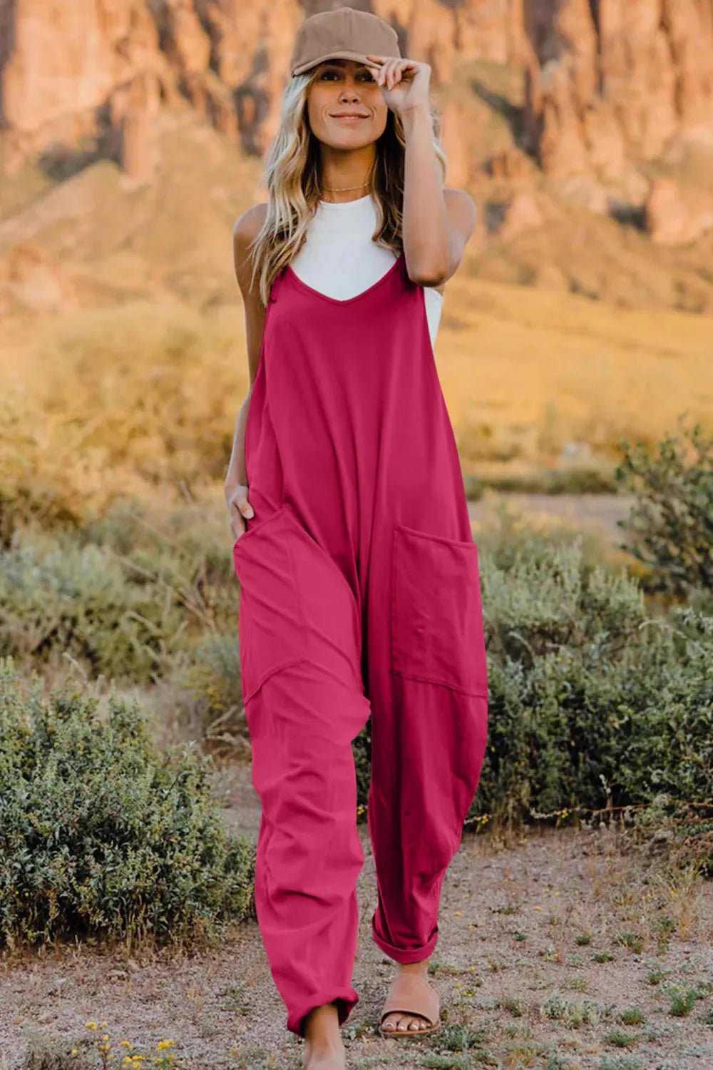 Women’s sleeveless V-neck jumpsuit by Plush Fashion Hub, lightweight casual romper with pockets, perfect for warm weather.