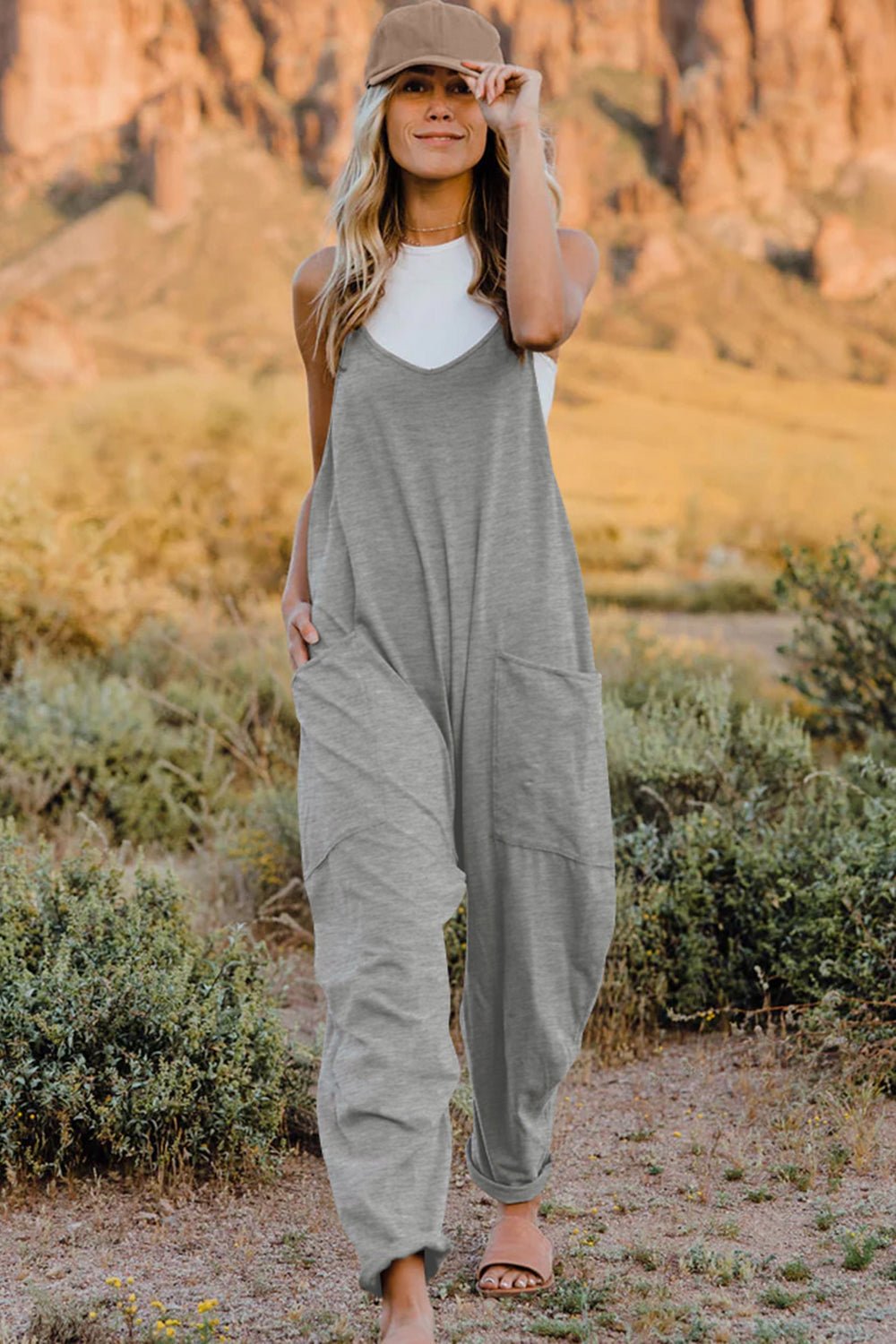 Women’s lightweight sleeveless V-neck jumpsuit with pockets, casual romper from Plush Fashion Hub, full-length view.