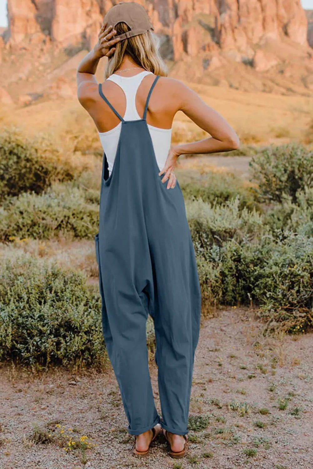 Women's sleeveless V-neck jumpsuit by Plush Fashion Hub featuring lightweight fabric and practical pockets, perfect for casual wear.