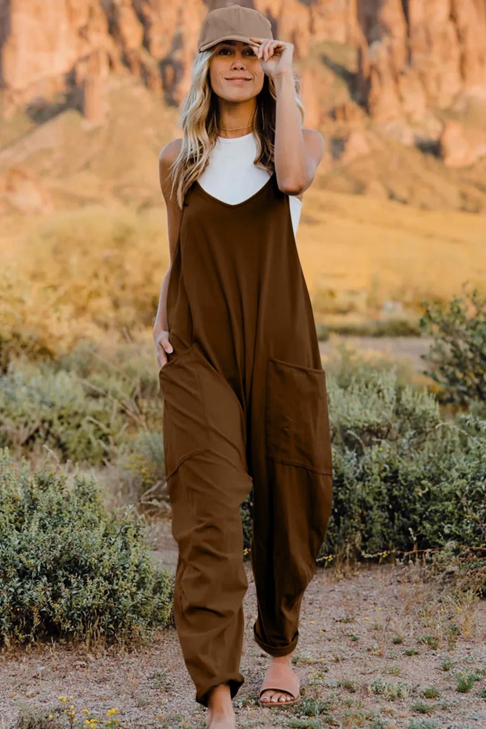 Women’s sleeveless V-neck jumpsuit by Plush Fashion Hub, lightweight casual romper with pockets and a relaxed fit.