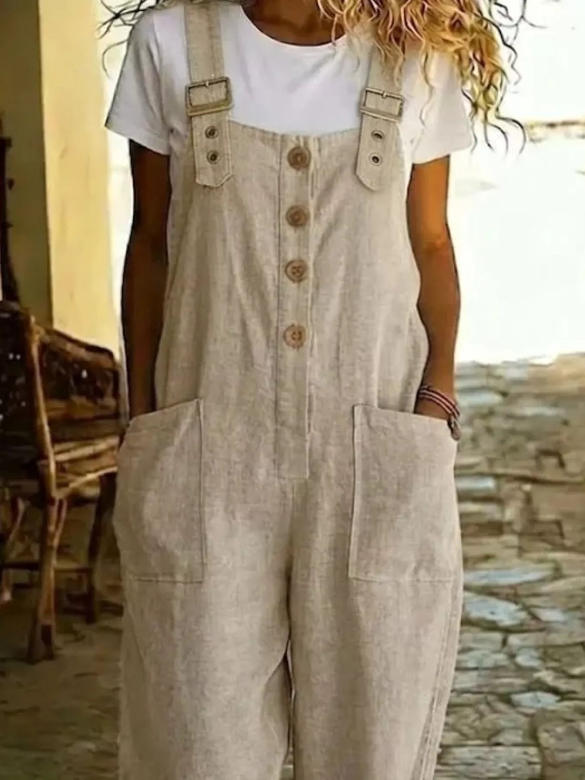 Casual button-front wide-leg overalls by Plush Fashion Hub, featuring adjustable straps and relaxed fit, worn with a casual top.