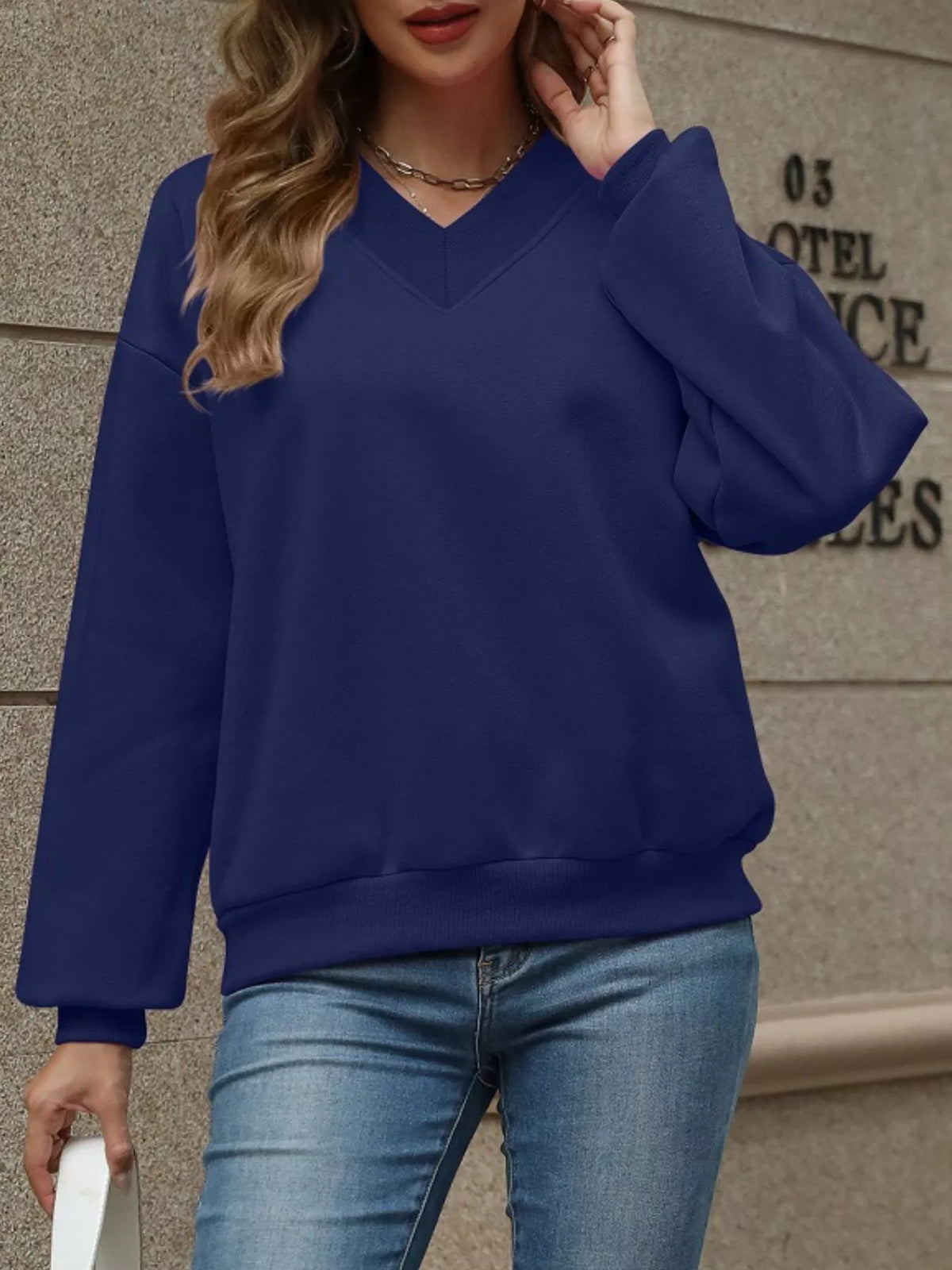 Slim fit V-neck solid color casual sweatshirt by Trendsi, showing soft fabric and classic design on a neutral background.