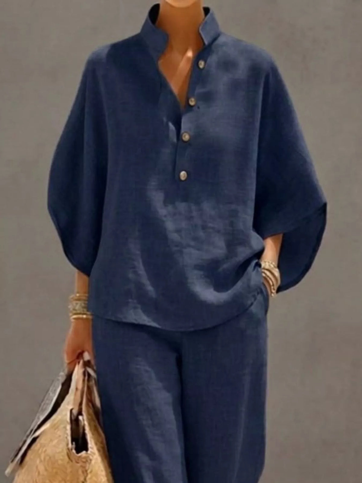 Women’s plus size two-piece set with button details and 3/4 sleeves, featuring a top and matching pants from Plush Fashion Hub.