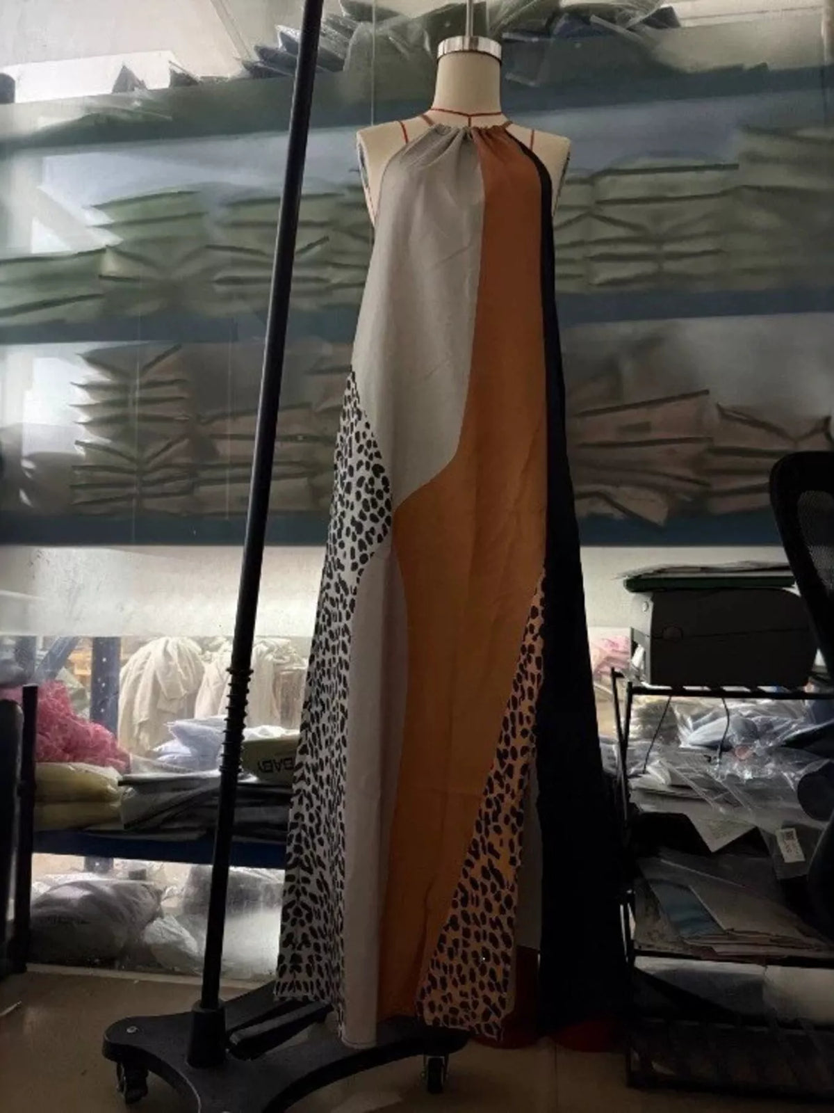 Color-block leopard print sleeveless maxi dress by Trendsi, showcasing bold pattern and flowing fabric in vibrant hues.