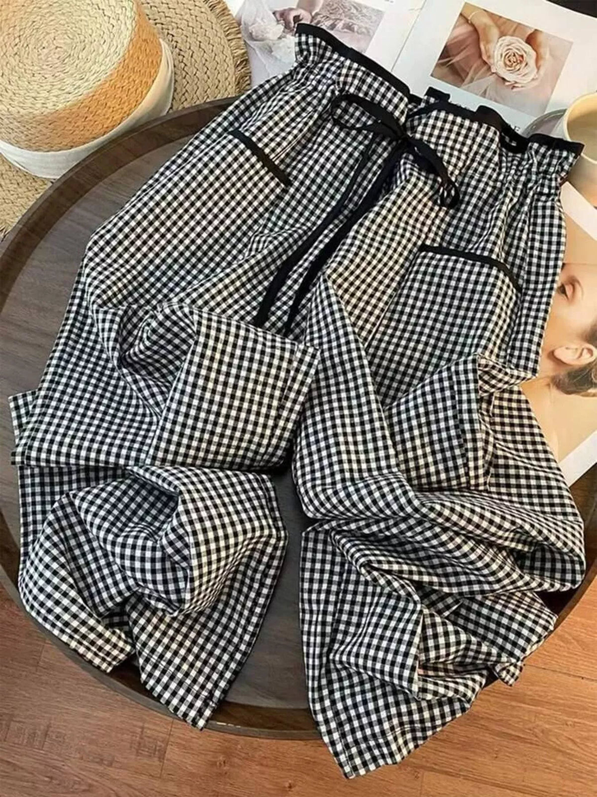 Women’s high-waisted gingham wide-leg pants with pockets by Plush Fashion Hub, featuring a stylish checkered pattern and flowing silhouette.