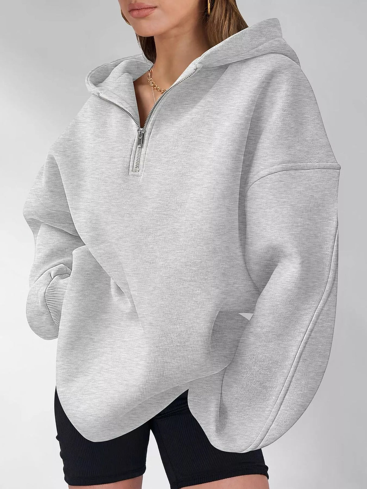 Oversized quarter-zip hoodie from Trendsi, showing a relaxed fit, soft fabric, and stylish design in a close-up view.