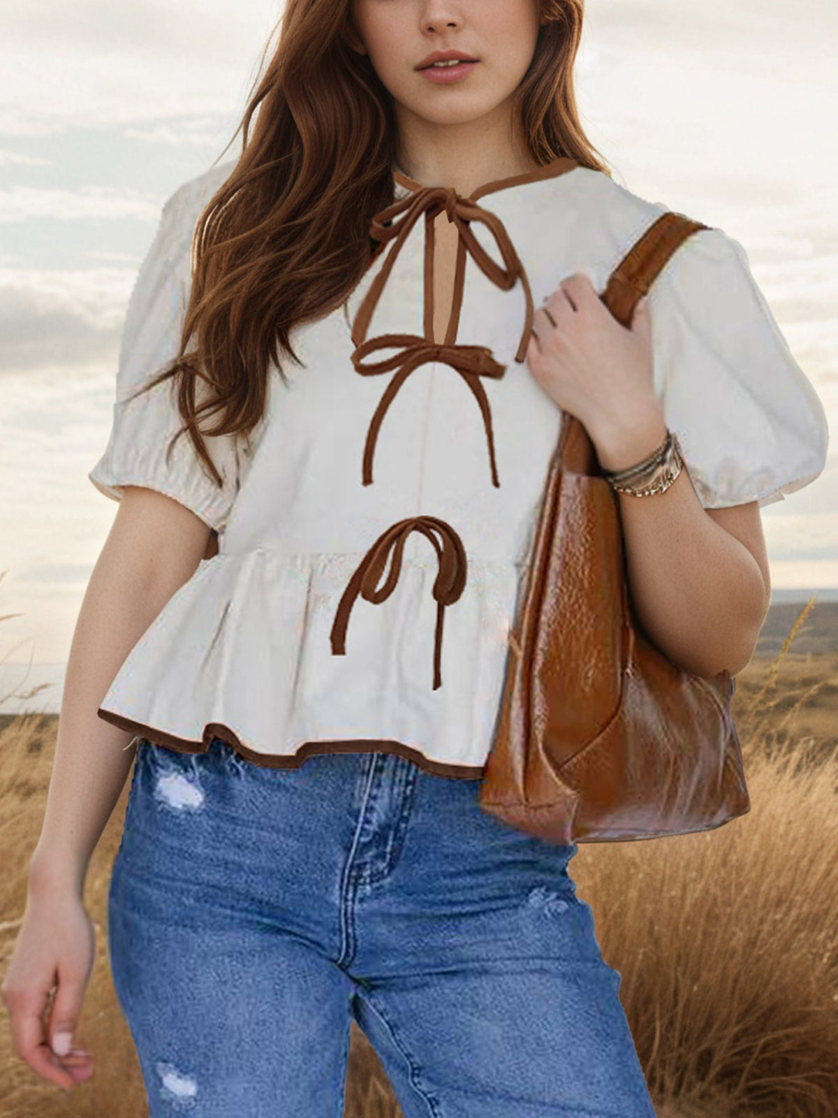 Plush Fashion Hub elegant tie-front puff sleeve peplum blouse with ruffled shoulders and fitted waist on model.