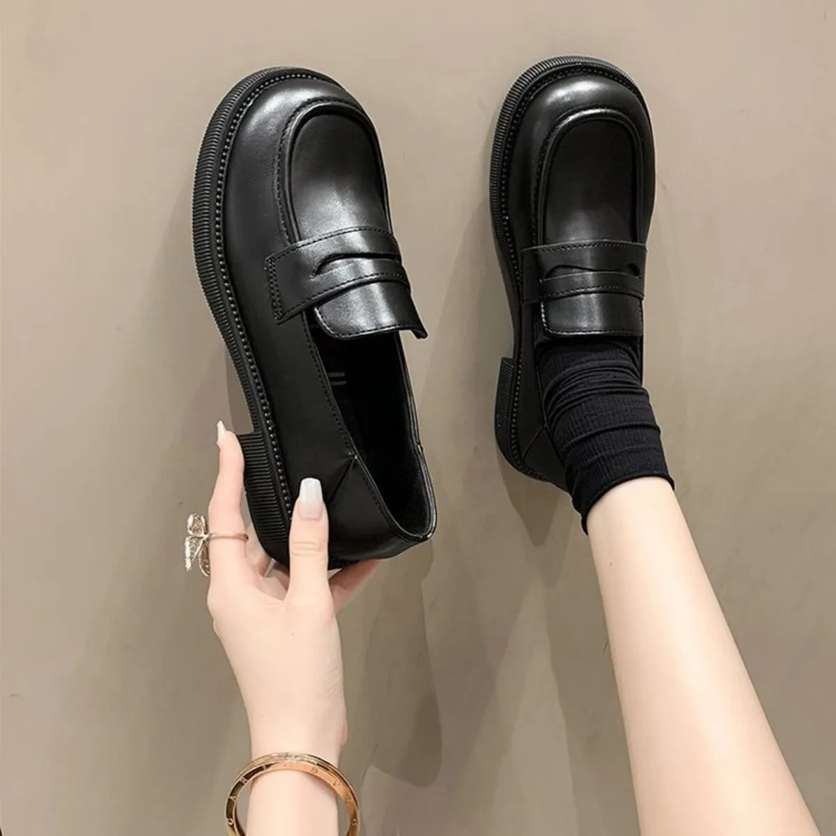 Women's round toe leather loafers by Trendsi, showing close-up of classic shoe design with smooth leather finish.