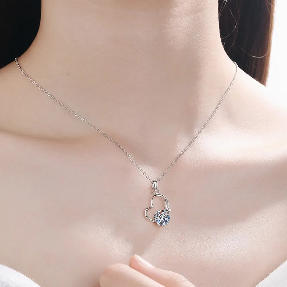 Sterling silver 2 carat moissanite heart necklace, elegant jewelry piece with sparkling gemstone and silver chain.