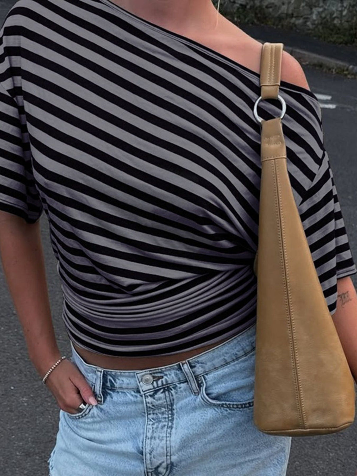 Women's asymmetrical striped one-shoulder T-shirt by Plush Fashion Hub featuring a stylish, modern design with bold stripes.