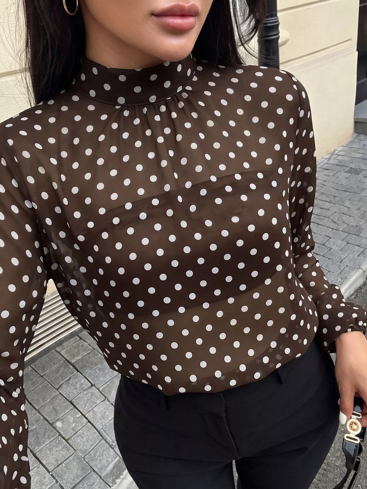 Polka dot mock neck long sleeve blouse by Trendsi, featuring a stylish black and white pattern and fitted design.