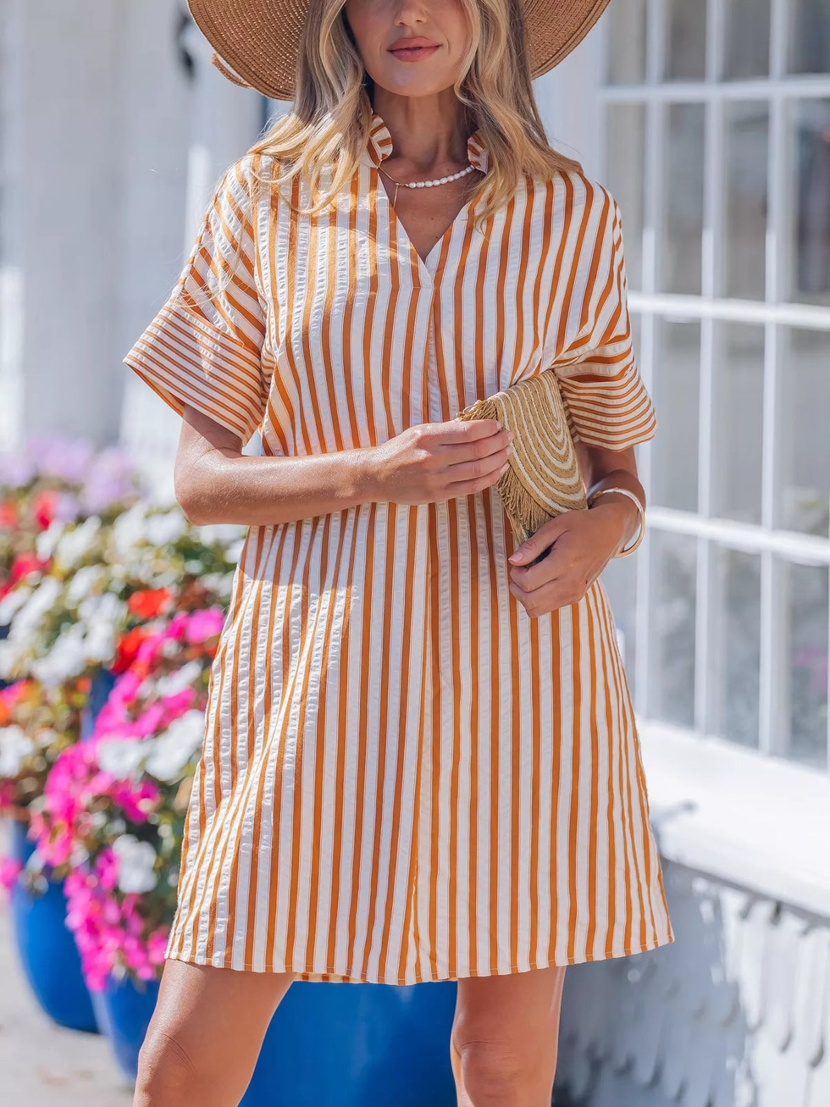 Striped V-neck mini dress with turn-up cuffs and pockets from Plush Fashion Hub, featuring a stylish and casual design.