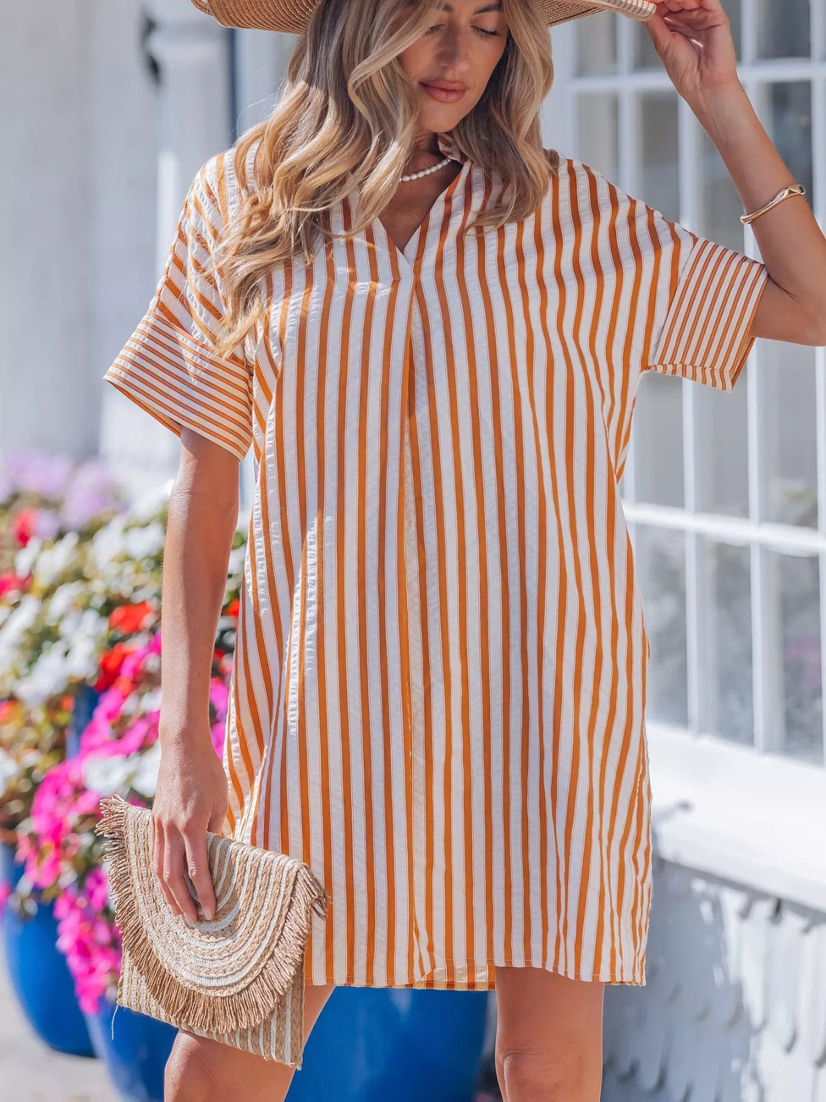 Striped V-neck mini dress with turn-up cuffs and pockets by Plush Fashion Hub, showcasing a stylish and casual dress design.
