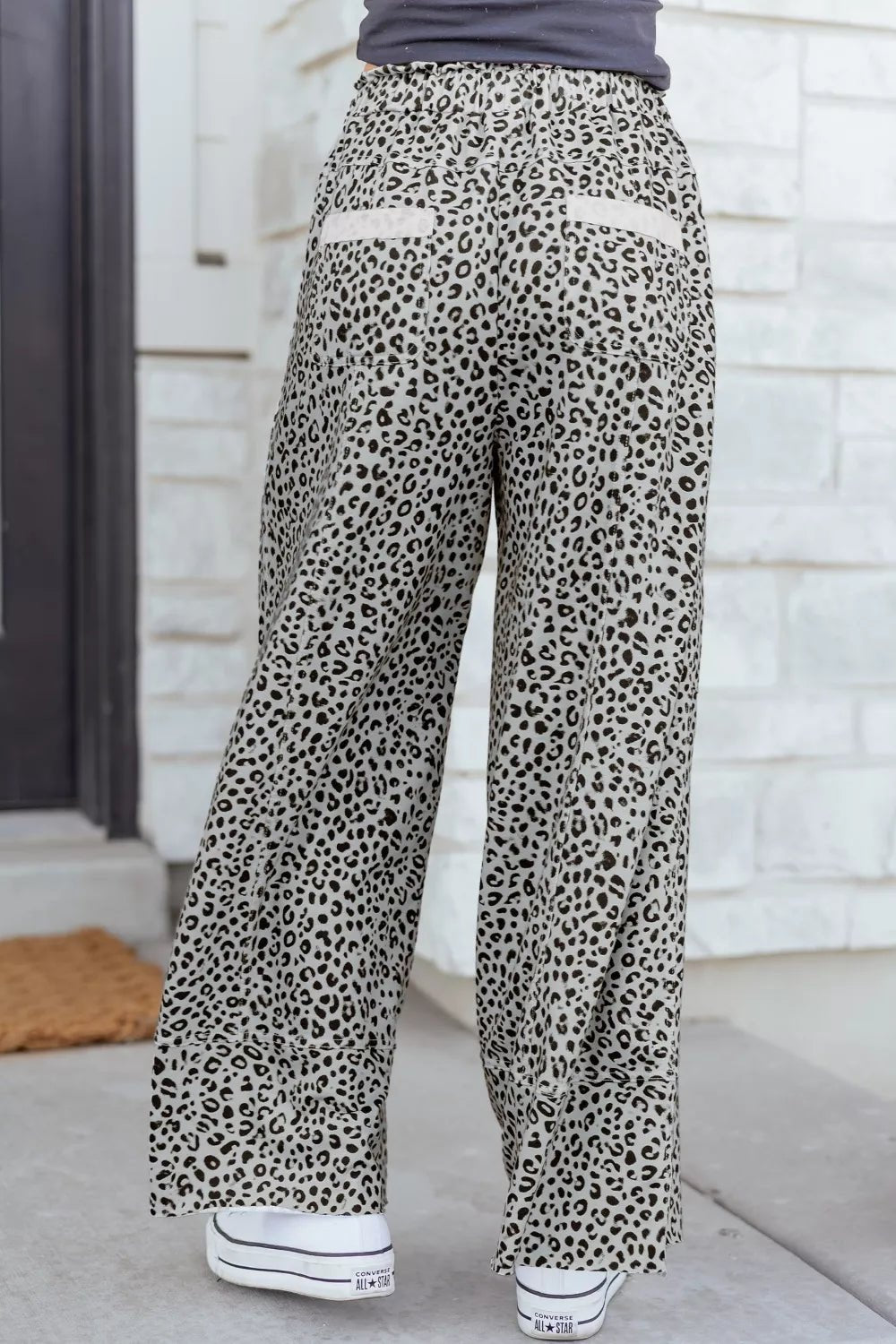 Women’s animal print wide-leg terry knit pants with drawstring waist from Plush Fashion Hub, shown on a model.