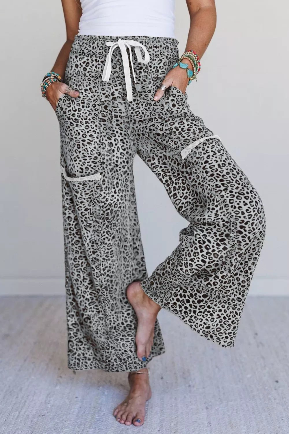 Women’s animal print wide-leg terry knit pants with drawstring waist by Plush Fashion Hub, shown on a model.