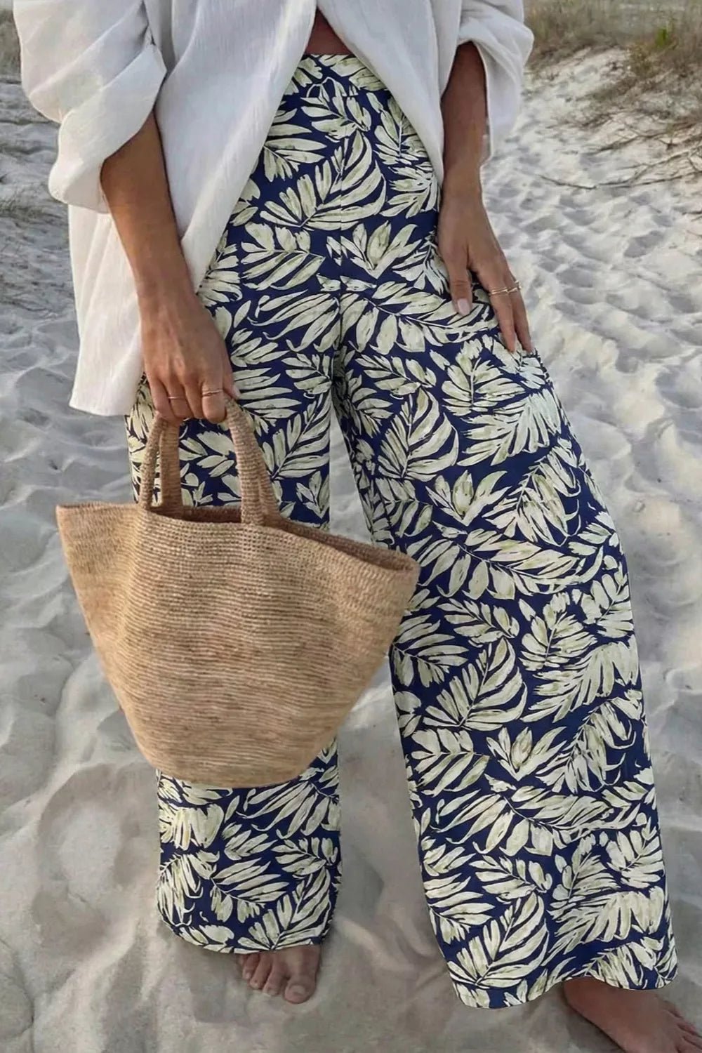 Women's high-waist leaf print wide-leg casual pants made of soft cotton blend, featuring a relaxed fit and comfortable style.